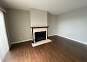 Thumbnail 40 of 41 - a living room with a fireplace and wooden floors
