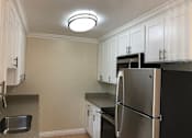 Thumbnail 25 of 62 - a kitchen with stainless steel appliances and white cabinets