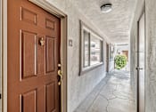 Thumbnail 46 of 52 - A brown door with a gold handle is on the left and a white door on the right.