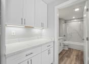 Thumbnail 63 of 67 - A white bathroom with a marble toilet and sink.