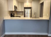 Thumbnail 47 of 51 - an empty kitchen with a counter top and a sink