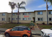 Thumbnail 12 of 14 - an office building with cars parked in front of it