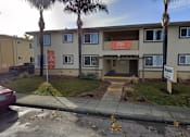 Thumbnail 14 of 14 - the front of an apartment building with palm trees