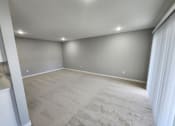 Thumbnail 15 of 16 - a room with a carpeted floor and gray walls and a window