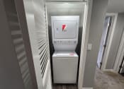Thumbnail 14 of 16 - a small laundry room with a washer and dryer