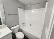 Thumbnail 13 of 16 - a bathroom with a tub and a toilet and a sink