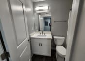 Thumbnail 12 of 16 - a small bathroom with a sink toilet and a mirror