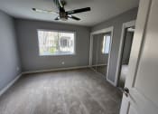 Thumbnail 10 of 16 - an empty room with a ceiling fan and a window