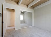 Thumbnail 29 of 32 - A room with a white tile wall and a carpeted floor.