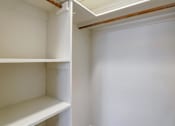 Thumbnail 19 of 38 - A white empty pantry with a white shelf and a white wall.