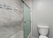 Thumbnail 21 of 53 - a bathroom with a toilet and a shower
