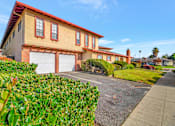 Thumbnail 13 of 13 - a house with two garage doors and a driveway in front of it