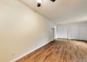 Thumbnail 34 of 43 - A room with wooden flooring and white walls.