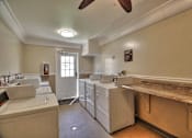 Thumbnail 12 of 33 - A laundry room with white appliances and a window.