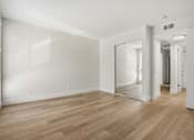 Thumbnail 89 of 92 - A room with wooden floors and white walls.