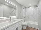 Thumbnail 55 of 67 - A white bathroom with a marble shower and a white toilet.