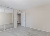 Thumbnail 49 of 51 - A room with a white door and a carpeted floor.