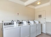 Thumbnail 28 of 42 - A row of sinks in a public restroom.