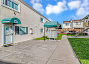 Thumbnail 22 of 40 - A rental office is located in a building with a green awning.