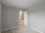 Thumbnail 32 of 60 - A room with a white door and carpeted floor.