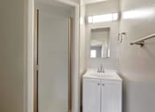 Thumbnail 20 of 38 - A white bathroom with a sink and mirror.