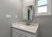 Thumbnail 20 of 53 - a bathroom with a sink and a mirror and a window