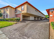Thumbnail 9 of 13 - a large building with a parking lot and a driveway