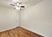 Thumbnail 37 of 43 - A room with a ceiling fan and a white door.