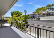 Thumbnail 41 of 92 - A balcony with a metal railing and a concrete floor.
