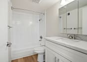 Thumbnail 84 of 92 - A white bathroom with a toilet, sink, and shower.