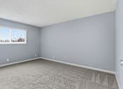 Thumbnail 53 of 55 - A room with a window and carpeted floor.