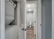 Thumbnail 19 of 53 - a laundry room with a closet and a toilet