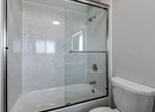 Thumbnail 52 of 53 - a white bathroom with a shower and a toilet