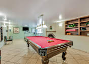 Thumbnail 29 of 42 - A pool table is in the middle of the room.