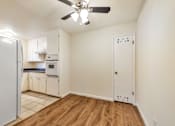 Thumbnail 33 of 43 - A kitchen with white cabinets and a white refrigerator.