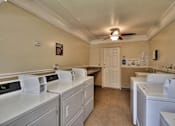 Thumbnail 13 of 33 - A laundry room with a washer and dryer in it.