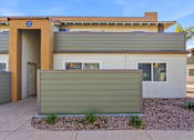 Thumbnail 64 of 67 - A modern house with a brown door and a green wall.