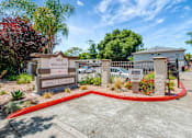 Thumbnail 6 of 25 - The image shows the entrance to the Willow Apartments with a sign and a red circular border.