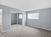 Thumbnail 30 of 55 - A room with grey walls and a carpeted floor.