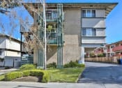 Thumbnail 1 of 7 - a street view of an apartment building with stairs on the side of it