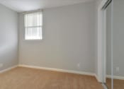 Thumbnail 23 of 35 - A room with a window and a carpeted floor.