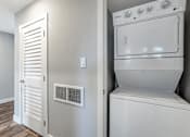 Thumbnail 18 of 53 - a white washer and dryer in a room with a door to a closet
