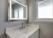 Thumbnail 51 of 53 - a bathroom with a sink and a mirror