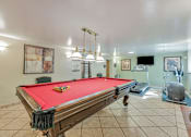 Thumbnail 35 of 42 - A pool table with a red cloth and a set of pool balls on it.