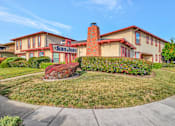 Thumbnail 10 of 13 - the front view of the building with a lawn and a sidewalk