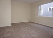 Thumbnail 21 of 22 - A room with a carpeted floor and a window.