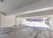 Thumbnail 36 of 43 - A car is parked in a white garage.