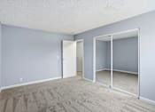 Thumbnail 34 of 55 - A room with a carpeted floor and a sliding glass door.