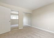 Thumbnail 15 of 37 - A room with a white door and a sliding glass door.