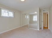 Thumbnail 26 of 37 - A room with a carpeted floor and a sliding glass door.